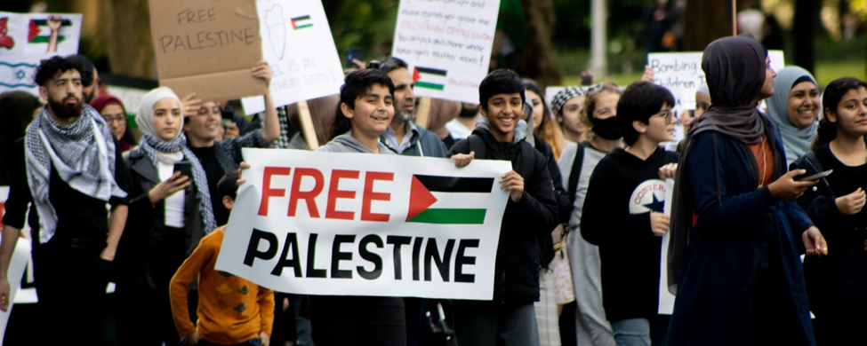 Protesters march with free Palestine signs